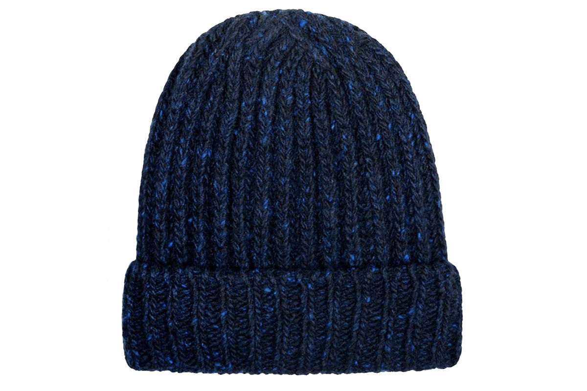 Keramikvasen und Porzellanblüten von Coco Loves Clay: eine kugelförmige und eine zylindrische weiße Vase mit strukturierter Oberfläche, dazu unglasierte Blüten und Zweige, arrangiert auf dunklem Untergrund mit weihnachtlichen Motiven.